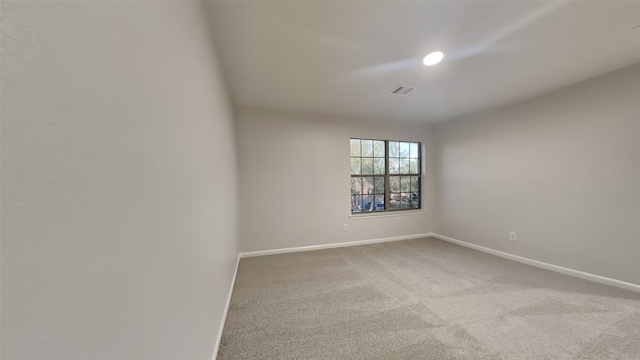 unfurnished room with visible vents, baseboards, and carpet floors