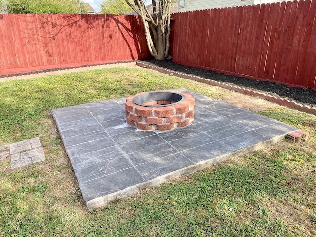 details with a fenced backyard and an outdoor fire pit