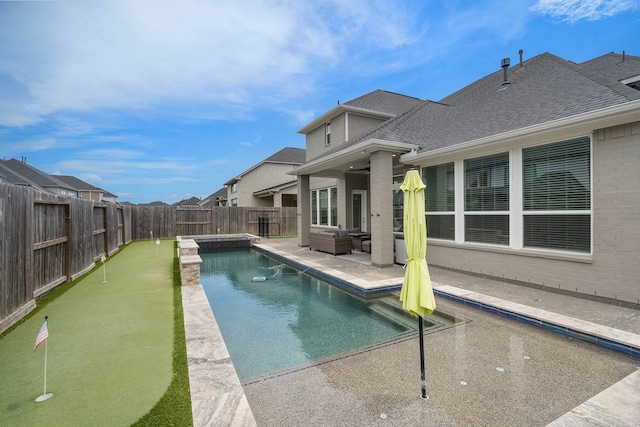 4411 Windy Oaks Dr, Fulshear, TX 77441 - view of swimming pool with an area to practice putting, a fenced backyard, a patio area, and an outdoor living space
