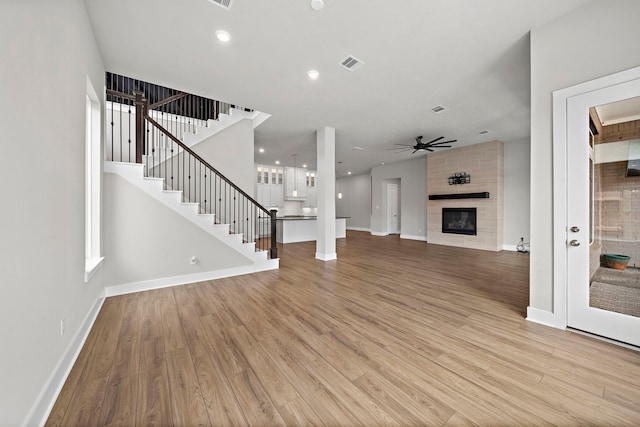 4411 Windy Oaks Dr, Fulshear, TX 77441 - unfurnished living room featuring light wood-style flooring, ceiling fan, baseboards, and recessed lighting
