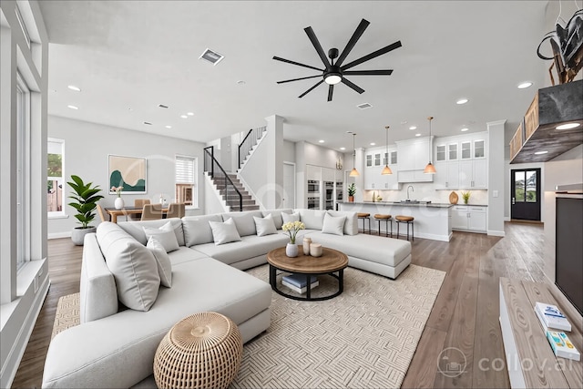 4411 Windy Oaks Dr, Fulshear, TX 77441 - living room with a ceiling fan, wood finished floors, recessed lighting, baseboards, and stairs