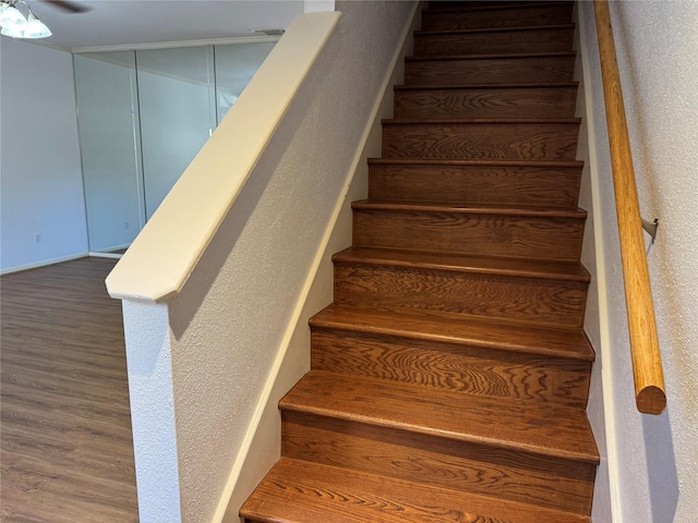9850 Pagewood Ln Unit 1001, Houston, TX 77042 - stairway with wood finished floors and a textured wall