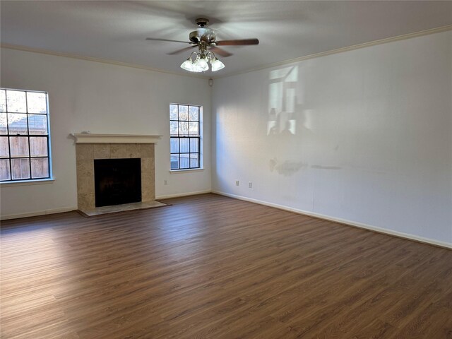 9850 Pagewood Ln Unit 1001, Houston, TX 77042 - unfurnished living room with crown molding, dark wood-type flooring, a ceiling fan, and plenty of natural light