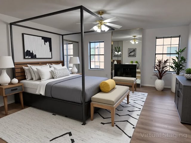 9850 Pagewood Ln Unit 1001, Houston, TX 77042 - bedroom featuring wood finished floors, ceiling fan, and baseboards