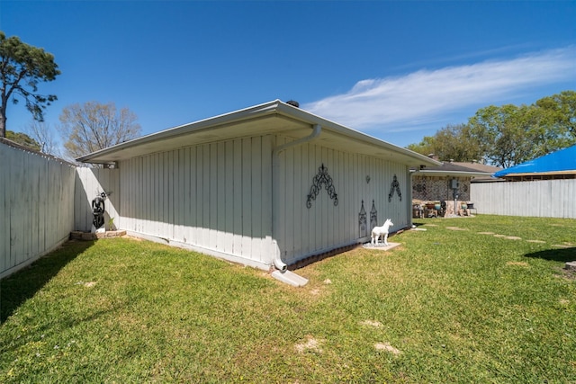 view of property exterior featuring a lawn and fence