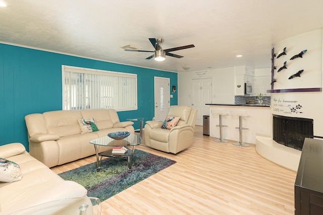 living room with recessed lighting, visible vents, ceiling fan, and wood finished floors