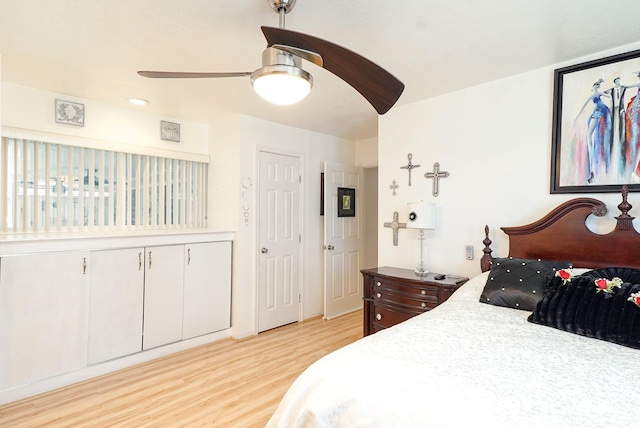 bedroom with a ceiling fan and light wood-type flooring