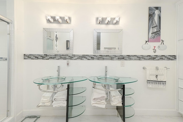 full bathroom with wainscoting, baseboards, marble finish floor, and a shower stall