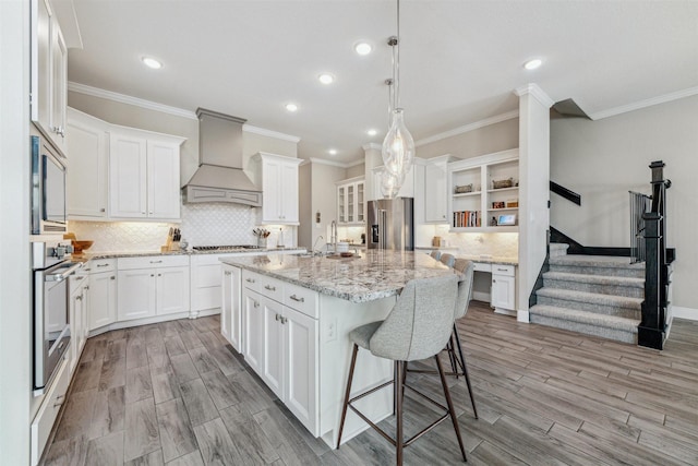 17934 Wichita River Way, Cypress, TX 77433 - kitchen with recessed lighting, premium range hood, open shelves, decorative backsplash, and appliances with stainless steel finishes