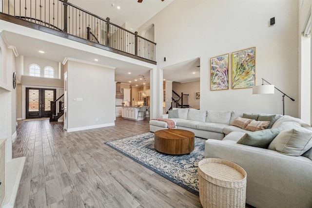 17934 Wichita River Way, Cypress, TX 77433 - living room featuring stairway, a towering ceiling, and wood finished floors