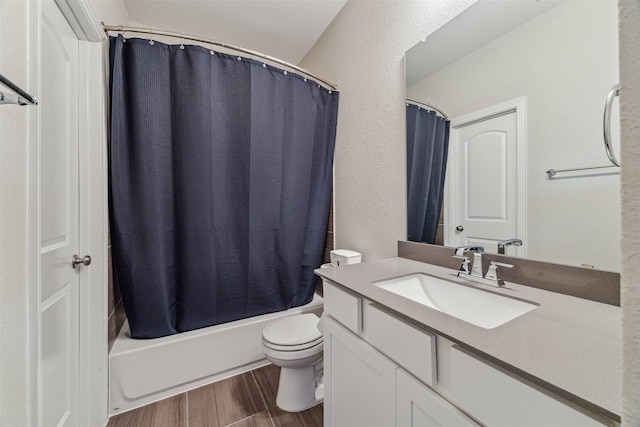 17934 Wichita River Way, Cypress, TX 77433 - full bathroom featuring toilet, wood finished floors, vanity, a textured wall, and shower / bath combination with curtain
