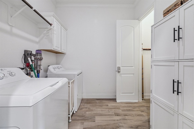17934 Wichita River Way, Cypress, TX 77433 - washroom featuring washer and clothes dryer, ornamental molding, cabinet space, and light wood-type flooring
