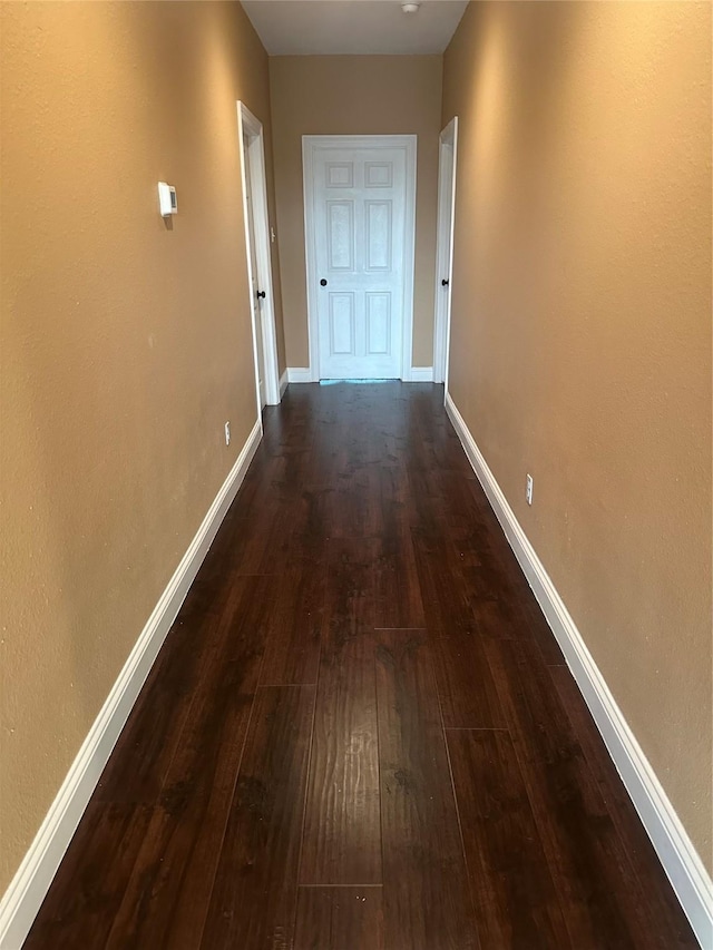 205 Rue Orleans St, Baytown, TX 77520 - hallway featuring dark wood finished floors and baseboards