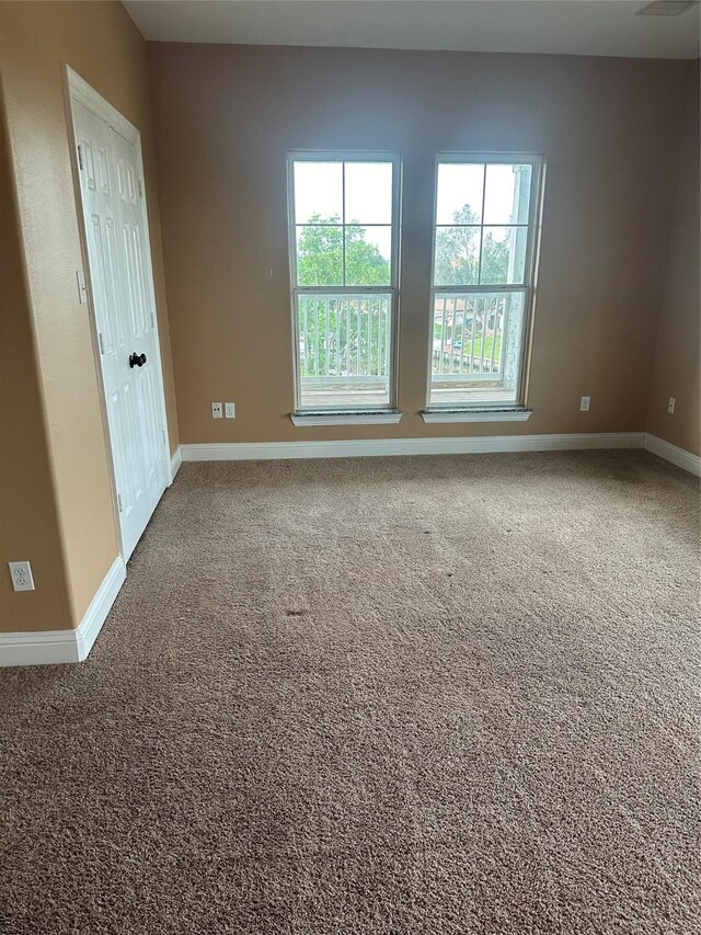 205 Rue Orleans St, Baytown, TX 77520 - spare room with baseboards and carpet floors