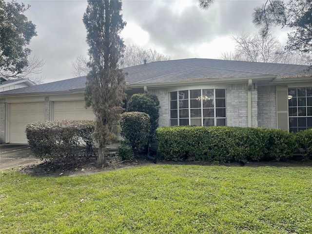 10415 Huntington Wood Dr, Houston, TX 77099 - view of side of home with a lawn, driveway, a shingled roof, and an attached garage