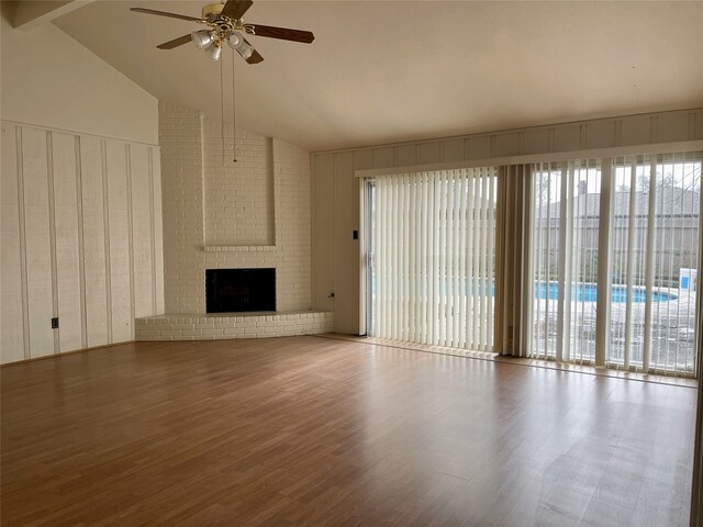 10415 Huntington Wood Dr, Houston, TX 77099 - unfurnished living room with high vaulted ceiling, wood finished floors, ceiling fan, and a brick fireplace