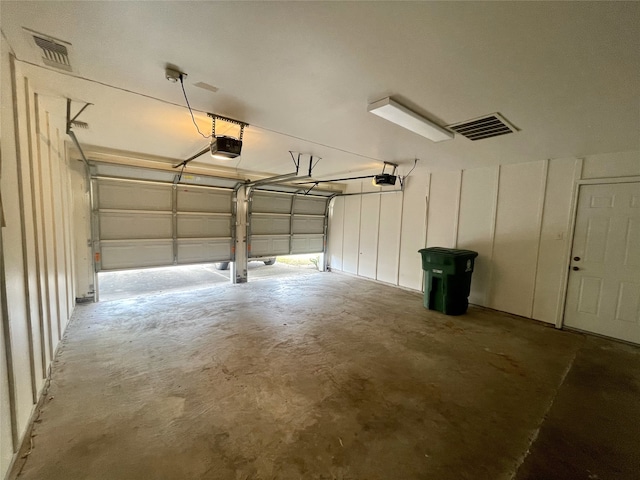 10415 Huntington Wood Dr, Houston, TX 77099 - garage featuring visible vents and a garage door opener