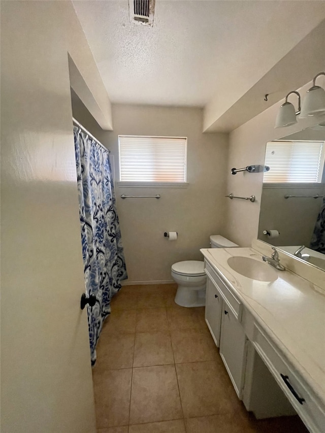 10415 Huntington Wood Dr, Houston, TX 77099 - full bathroom featuring a textured ceiling, visible vents, toilet, tile patterned floors, and vanity