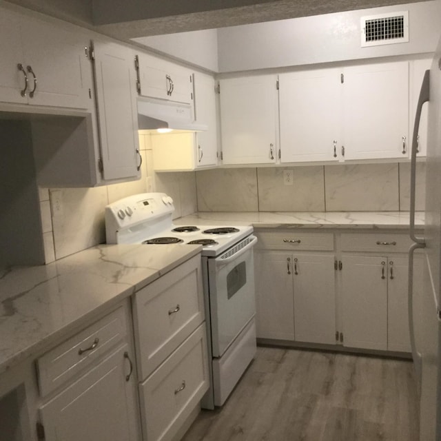 kitchen featuring visible vents, ventilation hood, white appliances, light wood-style floors, and backsplash