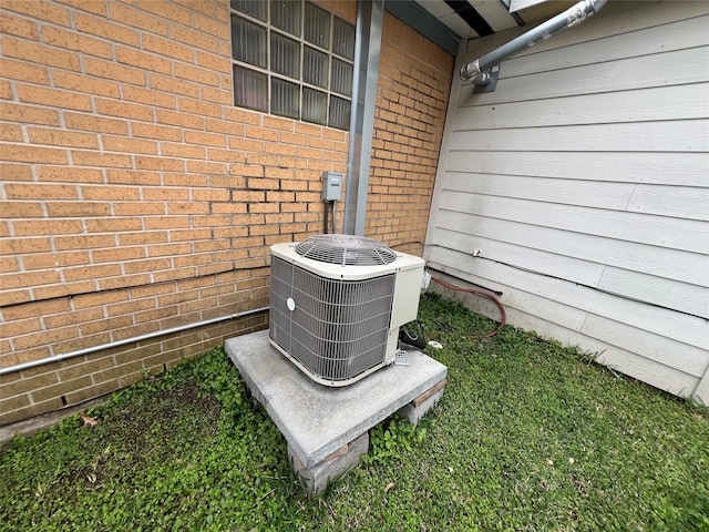 details with central air condition unit and brick siding