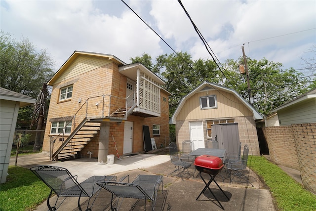 back of house with a patio area, fence, an outdoor structure, and stairway