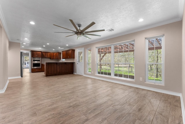 unfurnished living room featuring crown molding, a ceiling fan, a textured ceiling, light wood-type flooring, and visible vents