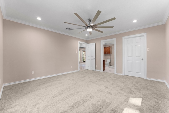 unfurnished bedroom with baseboards, visible vents, crown molding, and carpet floors