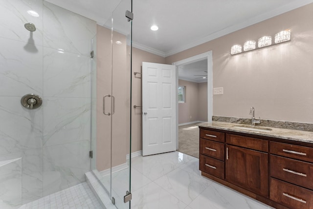 full bath with vanity, a marble finish shower, crown molding, baseboards, and marble finish floor