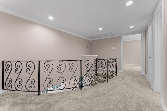 hall featuring an upstairs landing, ornamental molding, recessed lighting, attic access, and carpet floors