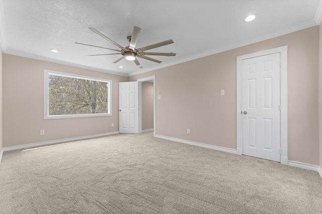 unfurnished bedroom with carpet floors, ornamental molding, and baseboards