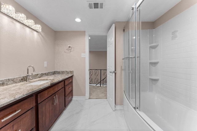 bathroom featuring combined bath / shower with glass door, vanity, marble finish floor, baseboards, and visible vents