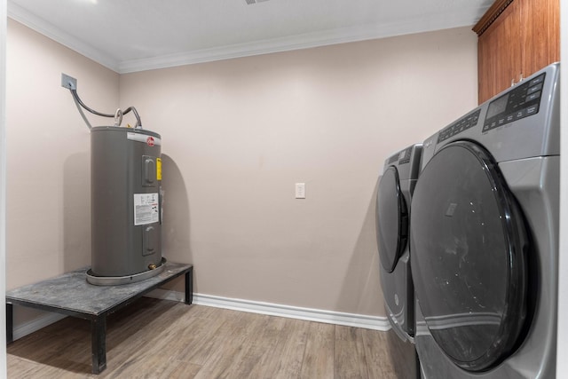 washroom with water heater, crown molding, separate washer and dryer, light wood-style flooring, and cabinet space