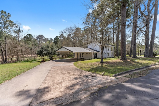 view of front of house featuring an attached carport, a front lawn, and concrete driveway