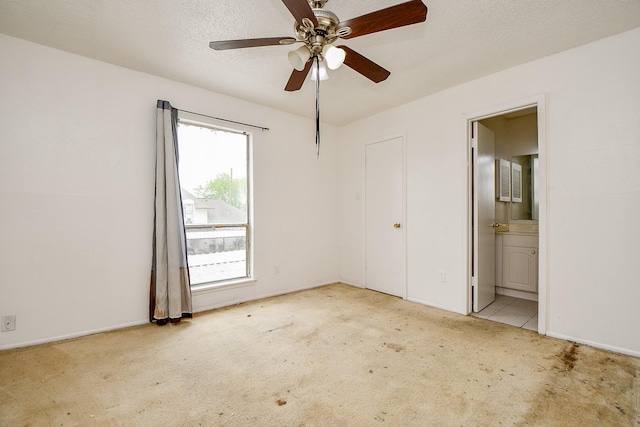7885 Cook Rd, Houston, TX 77072 - unfurnished bedroom with ensuite bath, a textured ceiling, ceiling fan, and carpet