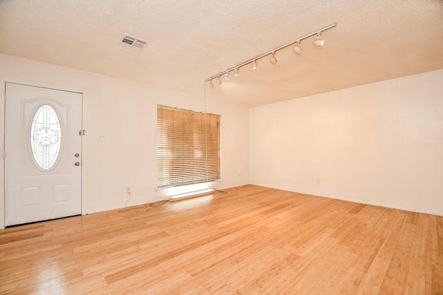 7885 Cook Rd, Houston, TX 77072 - entryway with a textured ceiling, visible vents, track lighting, and wood finished floors
