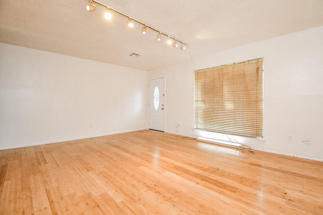 7885 Cook Rd, Houston, TX 77072 - interior space with hardwood / wood-style floors, baseboards, a textured ceiling, and visible vents