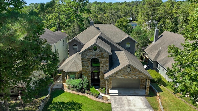 270 Lake Grove Dr, Coldspring, TX 77331 - view of front of property with stone siding, a garage, concrete driveway, a front yard, and a chimney