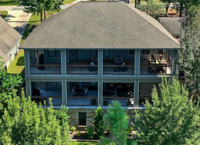 270 Lake Grove Dr, Coldspring, TX 77331 - back of property with roof with shingles, a balcony, and stone siding