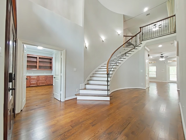 270 Lake Grove Dr, Coldspring, TX 77331 - stairway featuring a towering ceiling, ceiling fan, wood finished floors, and baseboards
