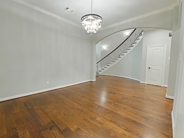 270 Lake Grove Dr, Coldspring, TX 77331 - unfurnished living room featuring arched walkways, ornamental molding, stairway, a chandelier, and wood finished floors