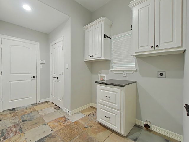 270 Lake Grove Dr, Coldspring, TX 77331 - laundry area featuring electric dryer hookup, baseboards, cabinet space, and hookup for a washing machine