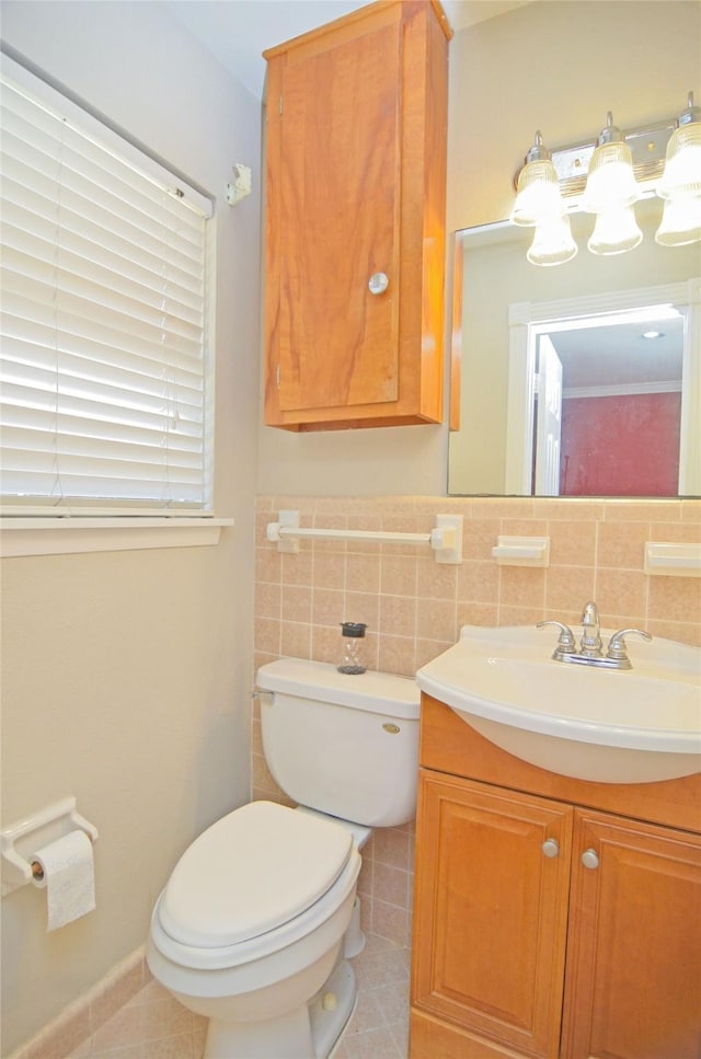 2719 Sweetgum St, Pasadena, TX 77502 - half bathroom featuring tile patterned flooring, toilet, vanity, tile walls, and wainscoting