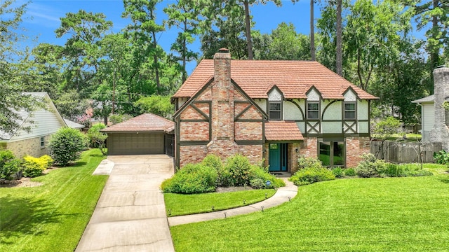 6522 Coral Ridge Rd, Houston, TX 77069 - tudor-style house featuring a chimney, a garage, a front yard, a tile roof, and brick siding