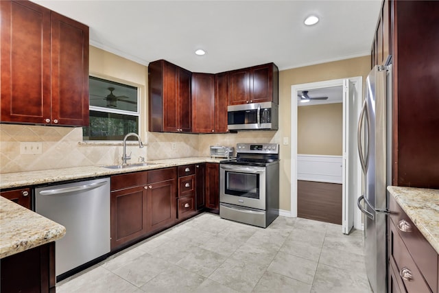 6522 Coral Ridge Rd, Houston, TX 77069 - kitchen featuring reddish brown cabinets, ceiling fan, a sink, and appliances with stainless steel finishes