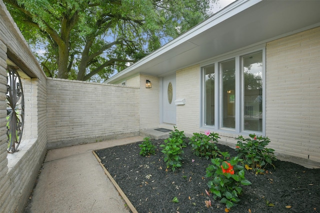property entrance featuring brick siding