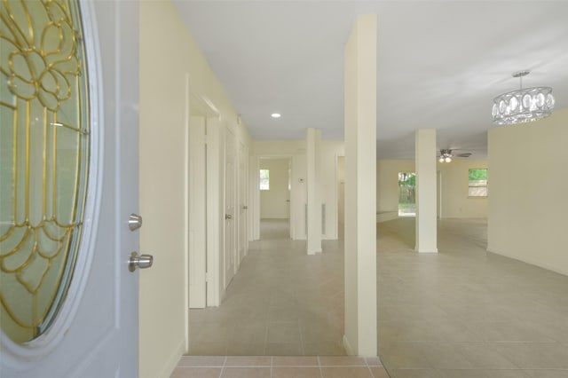 entrance foyer with recessed lighting, a healthy amount of sunlight, tile patterned floors, and ceiling fan with notable chandelier