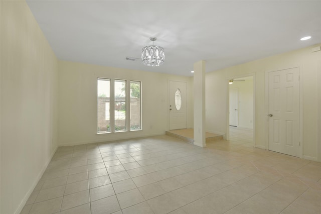 interior space featuring light tile patterned flooring, visible vents, baseboards, and an inviting chandelier