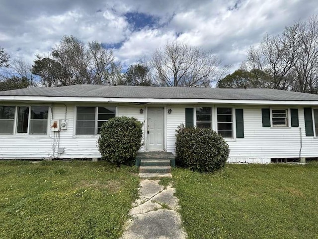 single story home with a front yard and roof with shingles