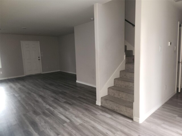 2395 Monroe St, Beaumont, TX 77703 - interior space with baseboards, wood finished floors, and stairway