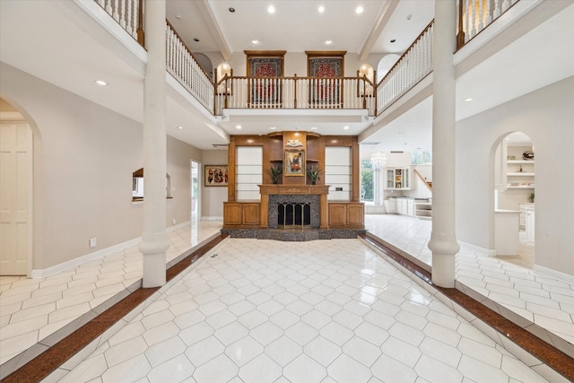 1204 Cowards Creek Dr, Friendswood, TX 77546 - unfurnished living room featuring recessed lighting, arched walkways, baseboards, and built in shelves